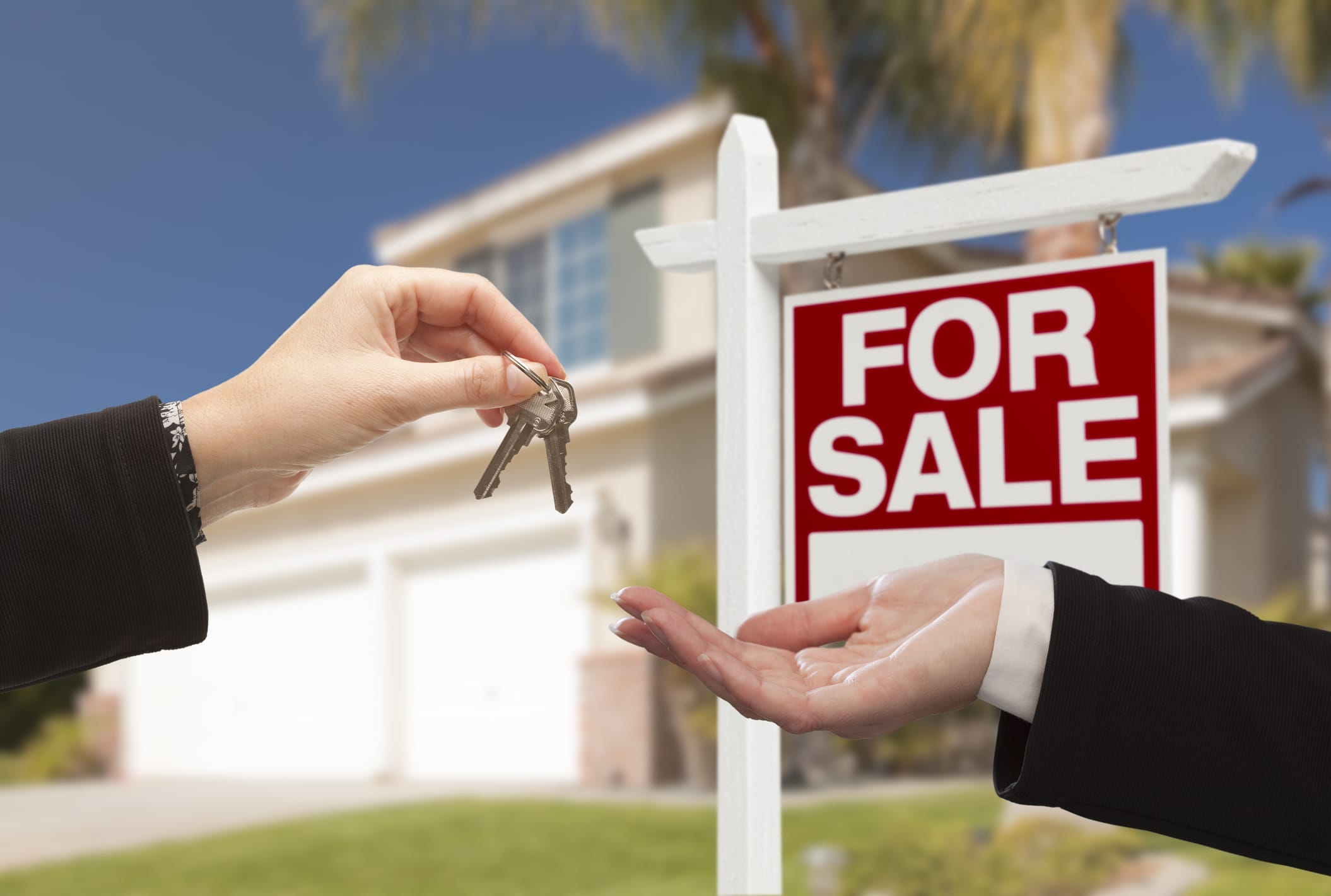 realtor handing over keys to homeowner with for sale sign in background RDS Environmental Colorado